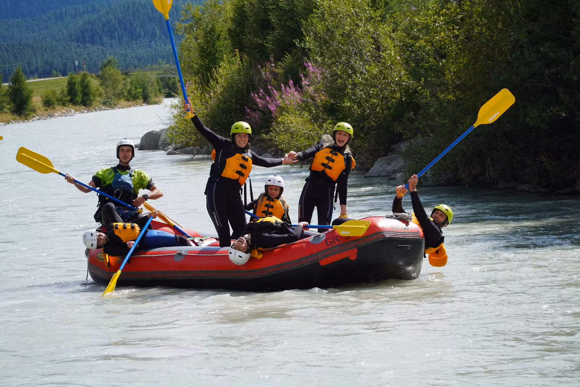 Family enjoying a thrilling rafting adventure on the Engadin river, showcasing excitement and teamwork.
