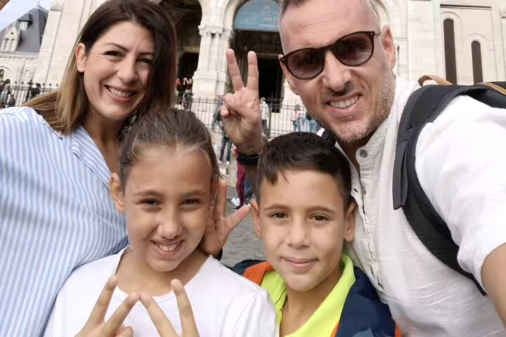 Family selfie near Sacré-Cœur Basilica, Montmartre stop on a Paris scavenger hunt and sights tour