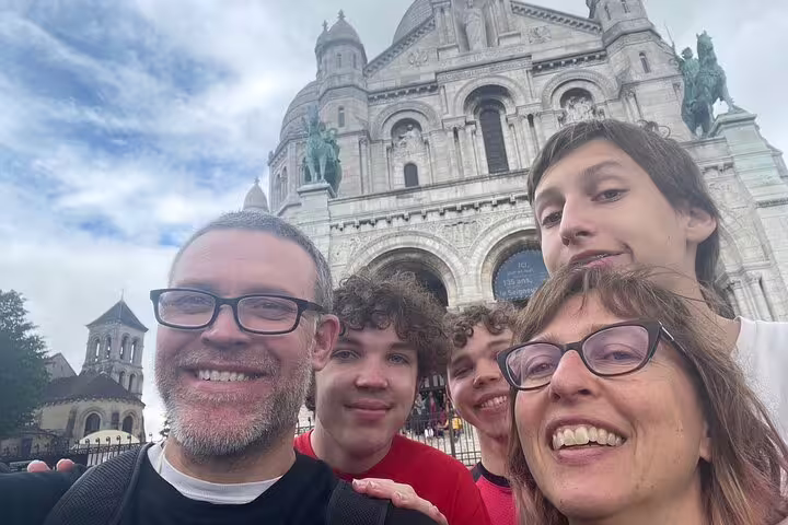 Family selfie with Sacré-Cœur Basilica backdrop, Montmartre Paris, on a self-guided scavenger hunt walk