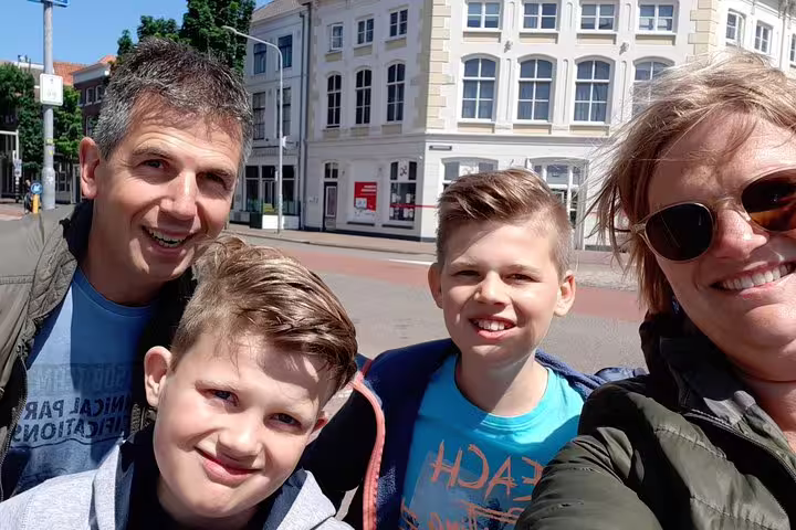 Smiling family selfie on a sunny city street, perfect for a Vienna e-scavenger hunt at your own pace