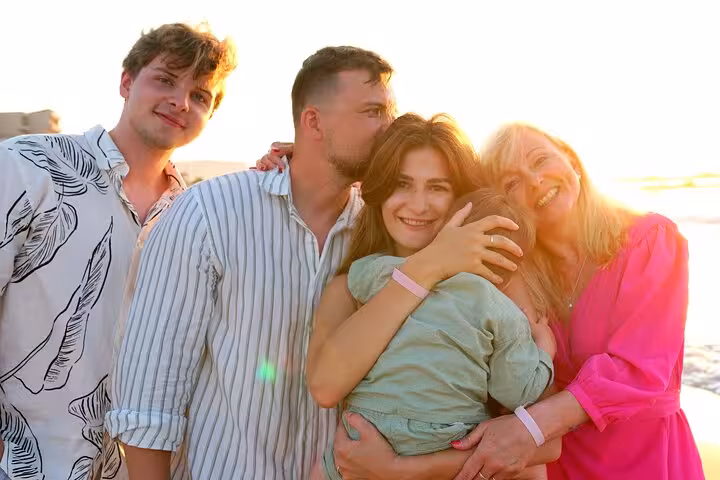 Family enjoying a sunset beach moment in Heraklion, ideal for capturing cherished memories in a photoshoot.
