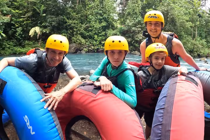 Family of four with inner tubes, geared up for an exciting tubing adventure on the Celeste River.