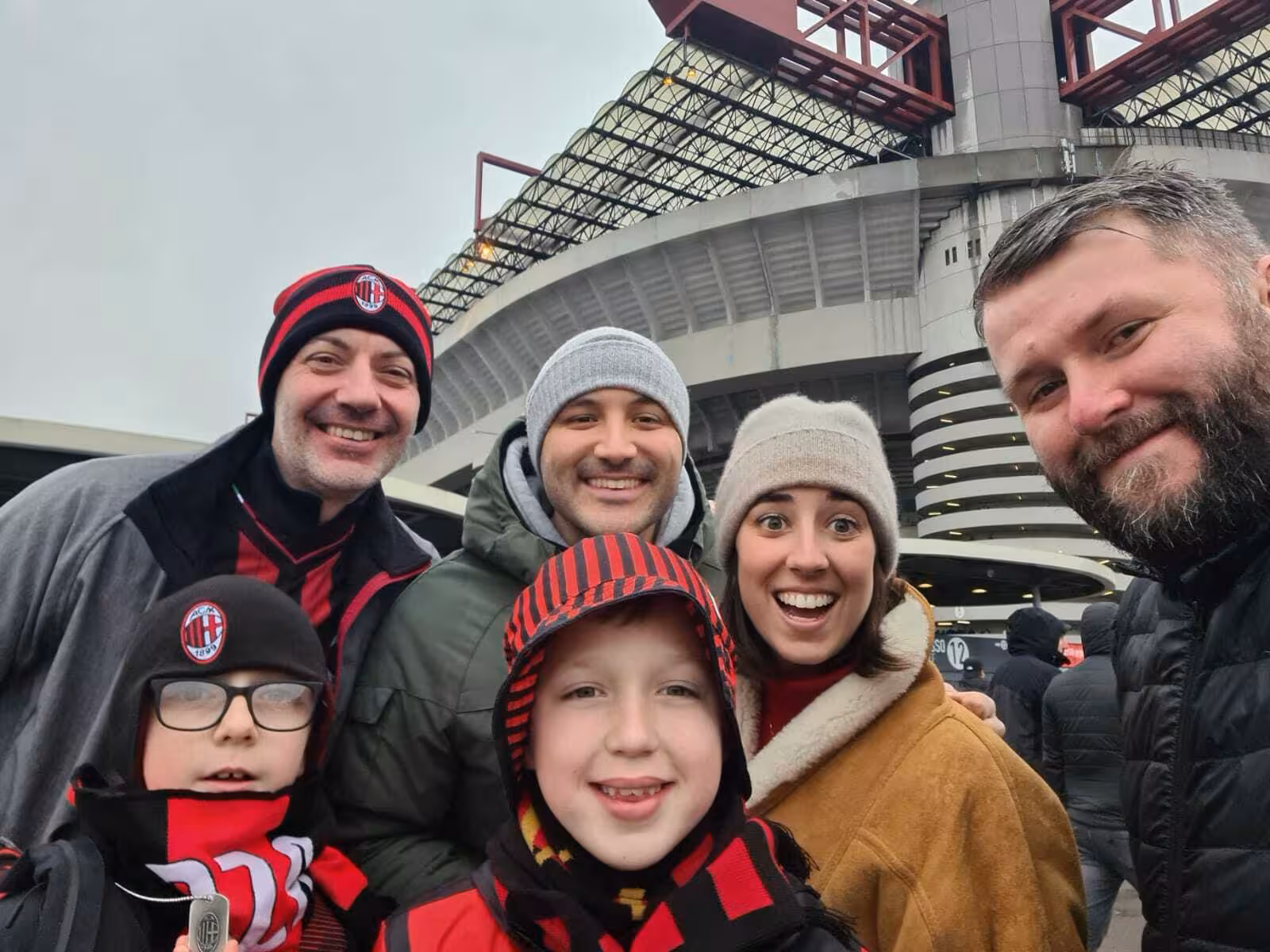 Fans pose outside San Siro in Milan before joining a local football match experience and stadium atmosphere
