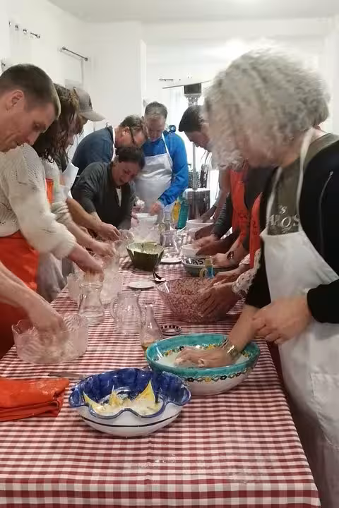 Guests tasting farm-made cheese and preparing pizza at a long table during wine and limoncello experience