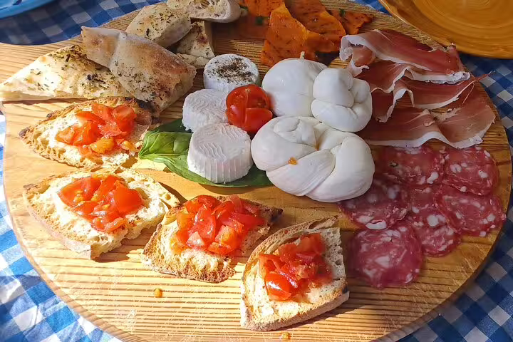 Farm tour tasting board with fresh mozzarella, salami and bruschetta, paired with local wine and limoncello