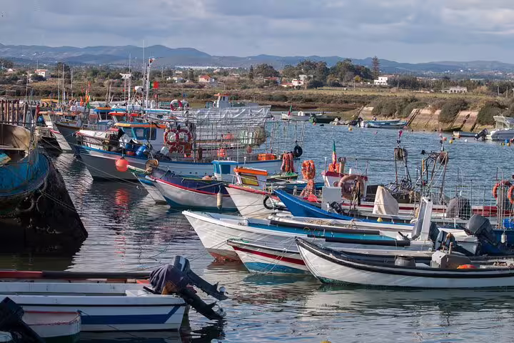 Traditional fishing boats moored on the Guadiana River near Vila Real de Santo António, Algarve day trip from Faro