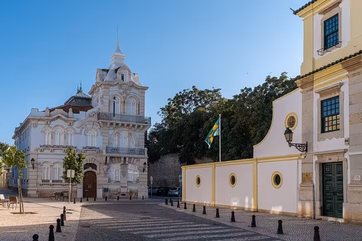 Historic architecture and vibrant flag in Faro's city center, ideal for an enriching introductory city walk.