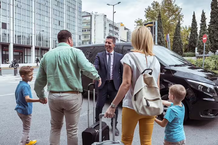 Driver greeting family by private van for Faro to Lisbon transfer, comfortable ride with 2-hour Évora sightseeing stop