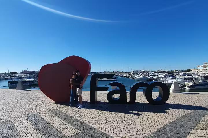 Scenic view of Faro marina with iconic heart sculpture, perfect for a memorable Algarve walking tour experience.