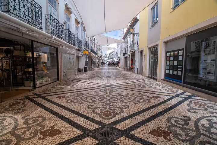 Charming street with intricate mosaic pavement in Faro, perfect for a cultural city walk with a local guide.