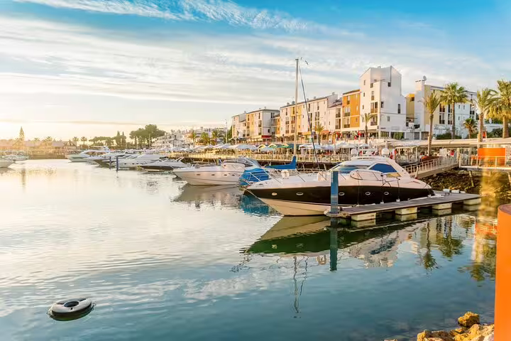 Marina with luxury yachts and waterfront promenade in Algarve, ideal stop on Faro to Sagres private tour