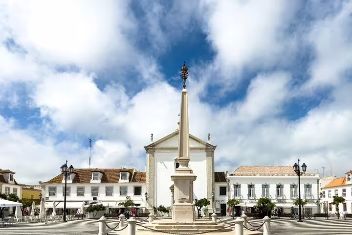 Sunny town square with obelisk and whitewashed buildings on Scenic Algarve day trip from Faro to Vila Real
