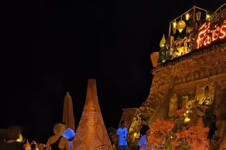 Night view of Farsha Cafe Sharm El Sheikh with lanterns and terrace seating on private car tour to Soho Square