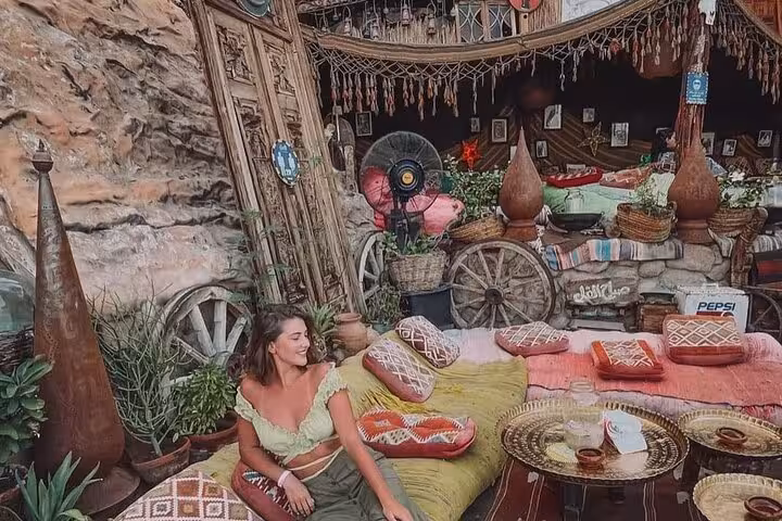 Traveler relaxing on colorful cushions at Farsha Cafe Sharm El Sheikh during guided city sightseeing tour