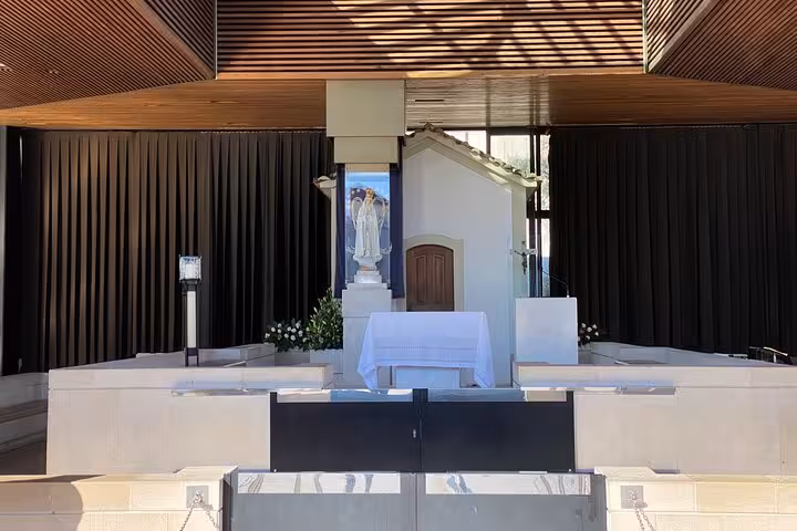 Chapel of Apparitions in Fatima with a statue of Our Lady and a serene altar, highlighted by natural light.