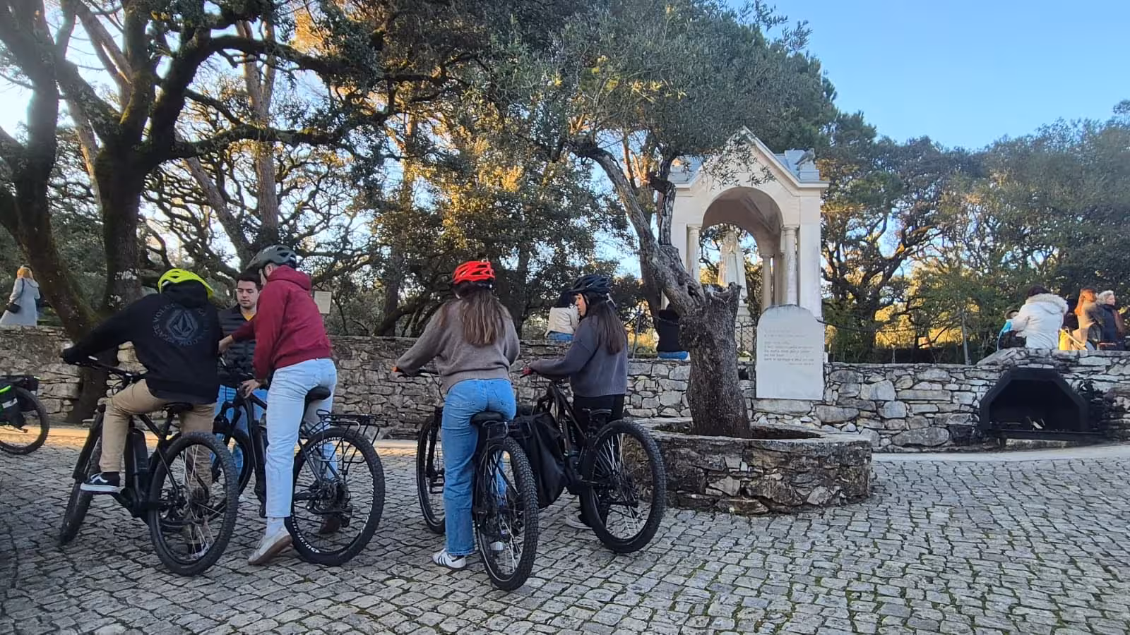 Guided e-bike group stop at a Fátima shrine viewpoint, exploring Sanctuary, Aljustrel and Valinhos route