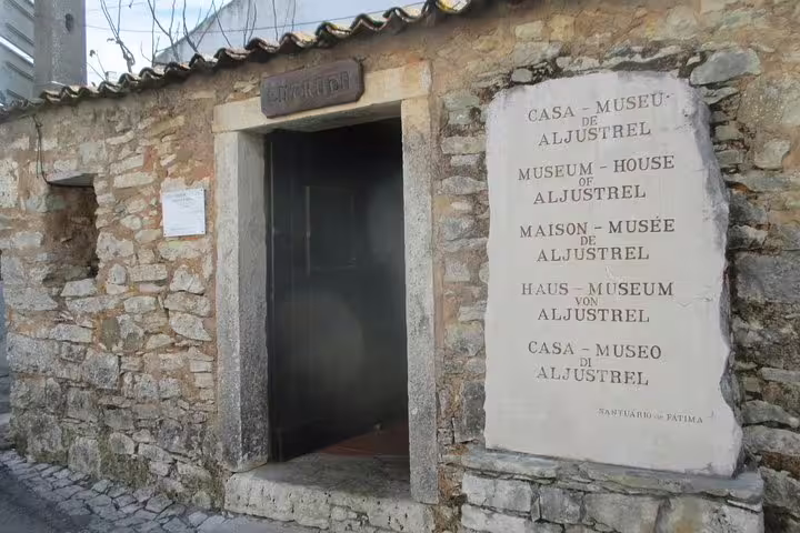 Historic stone entrance to the Museum House of Aljustrel, a highlight in the Fatima, Nazare, and Obidos private full-day tour.