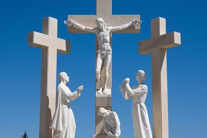 Statues depicting a religious scene under a clear blue sky in Fátima, highlighting cultural heritage on a full-day tour.