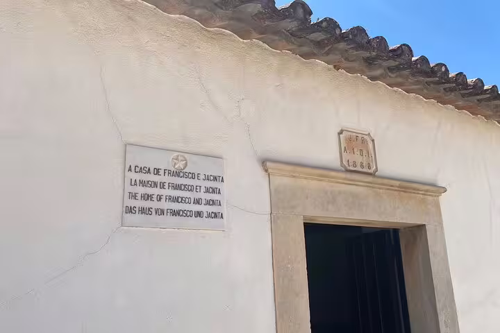 Entrance to Francisco and Jacinta's historic home in Aljustrel, a key stop on the Fátima pilgrimage tour.
