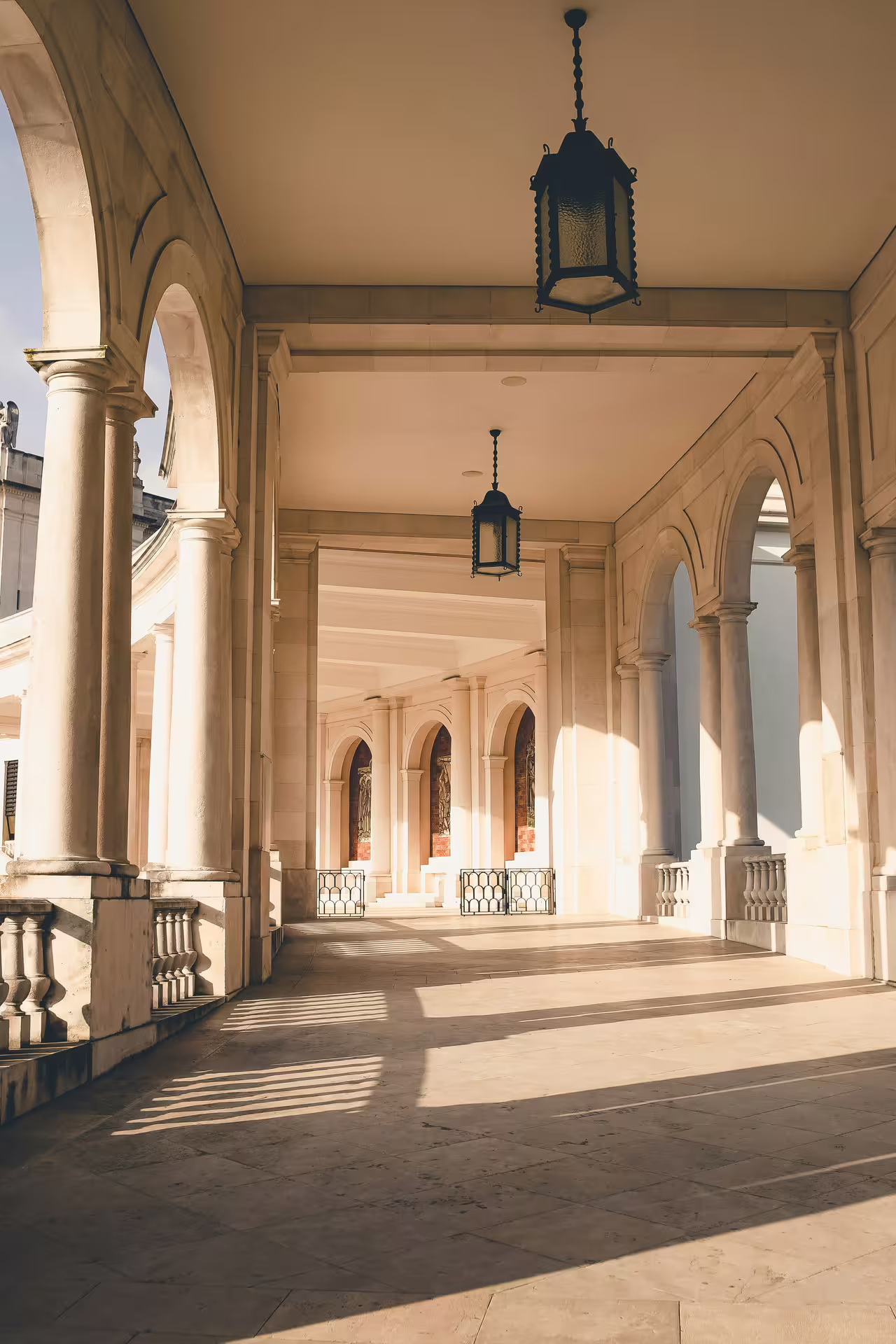 Sunlit arched colonnade at Fátima Sanctuary, part of Lisbon's Fátima and Santarém spiritual and historical day tour.