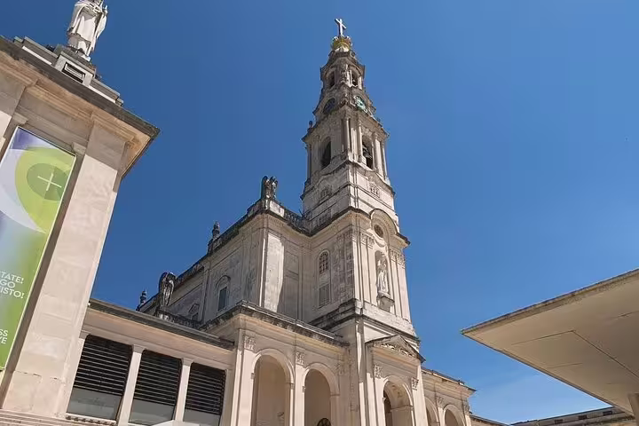 Majestic view of Fátima Sanctuary's basilica on a sunny day, ideal for a small group day trip from Lisbon.