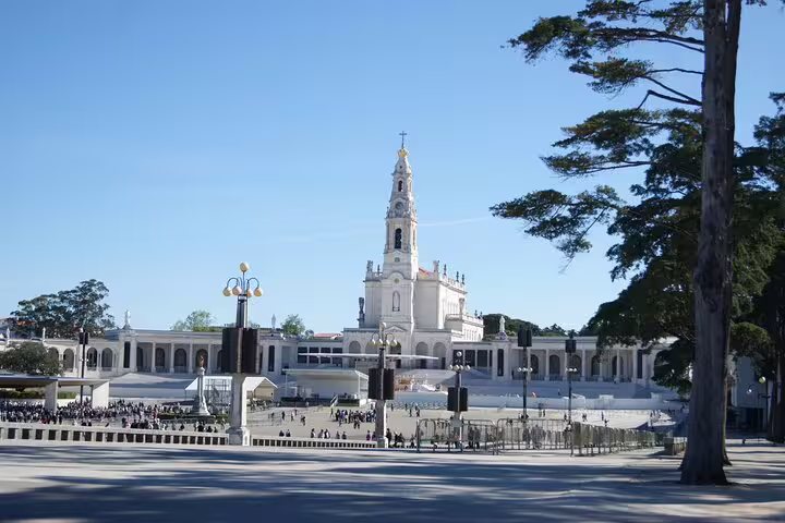 Fátima Sanctuary's basilica and plaza on a sunny day, a highlight of tours from Lisbon.