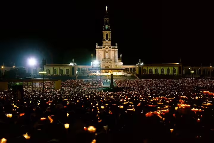 Evening candlelit procession at the Sanctuary of Fatima, showcasing its majestic architecture and spiritual ambiance.