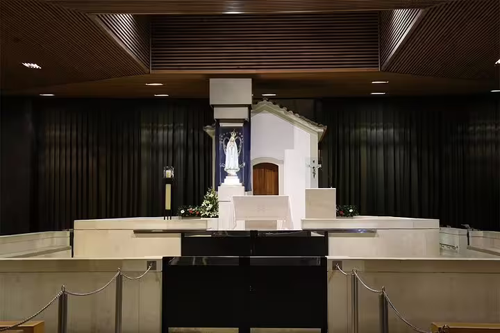Interior view of a chapel at the Sanctuary of Fátima, featuring a statue of the Virgin Mary on the Lisbon tour.
