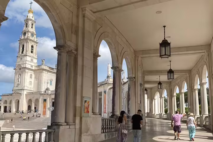 Stroll through the elegant colonnades of Fátima Sanctuary, capturing its historic charm on a guided tour.