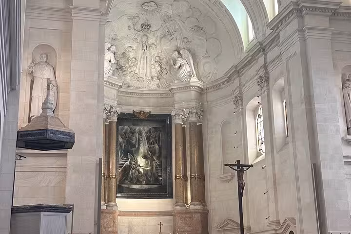 Intricate interior view of the Sanctuary of Our Lady of Fatima with religious sculptures and artwork, showcasing spiritual heritage.