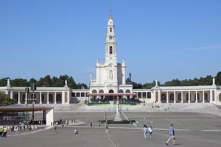 The majestic facade of the Sanctuary of Fátima, a significant stop on the Lisbon to Porto transfer tour.