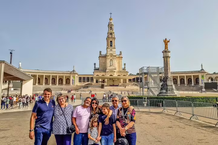 Tourists enjoying a sunny day at the Sanctuary of Fátima, a highlight of the Biggest Caves and Fátima full-day private tour.