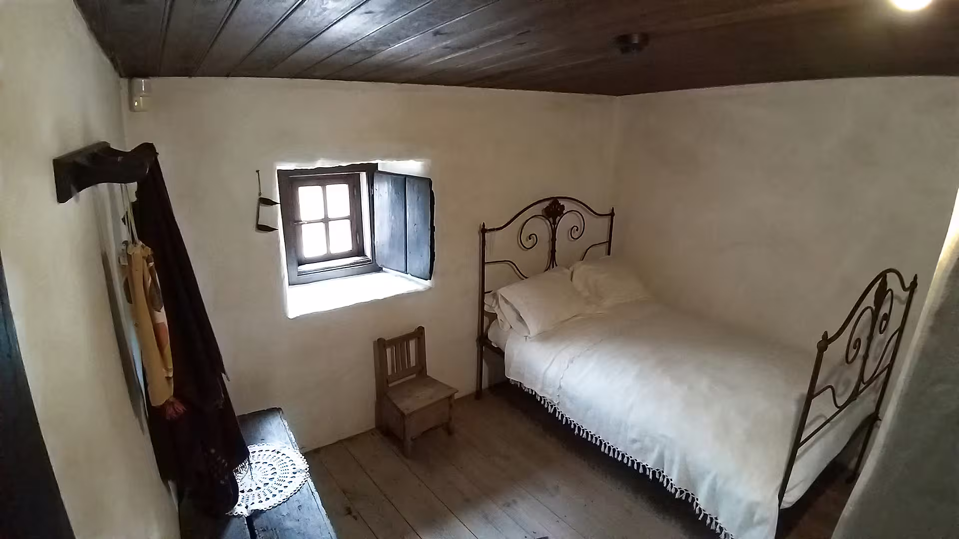 Cozy interior of a traditional bedroom at the Little Shepherds Houses, part of the Fátima Sanctuary private tour experience.