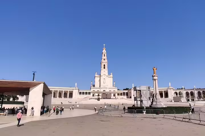 Scenic view of the Sanctuary of Our Lady of Fatima under a clear blue sky, a highlight on the private day tour to Fatima, Batalha, Nazaré, and Obidos.