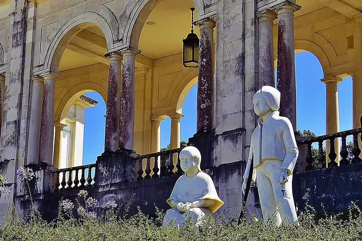 Statues of the Little Shepherds framed by arched pillars at the Fatima Shrine, capturing historical and religious significance.
