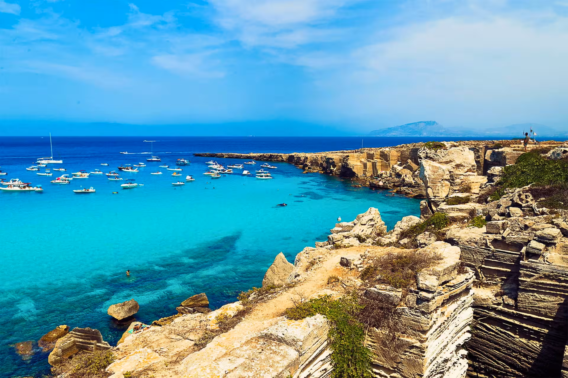 Panoramic Favignana coastline with crystal-clear water and boats, Egadi Islands boat excursion from Trapani with lunch