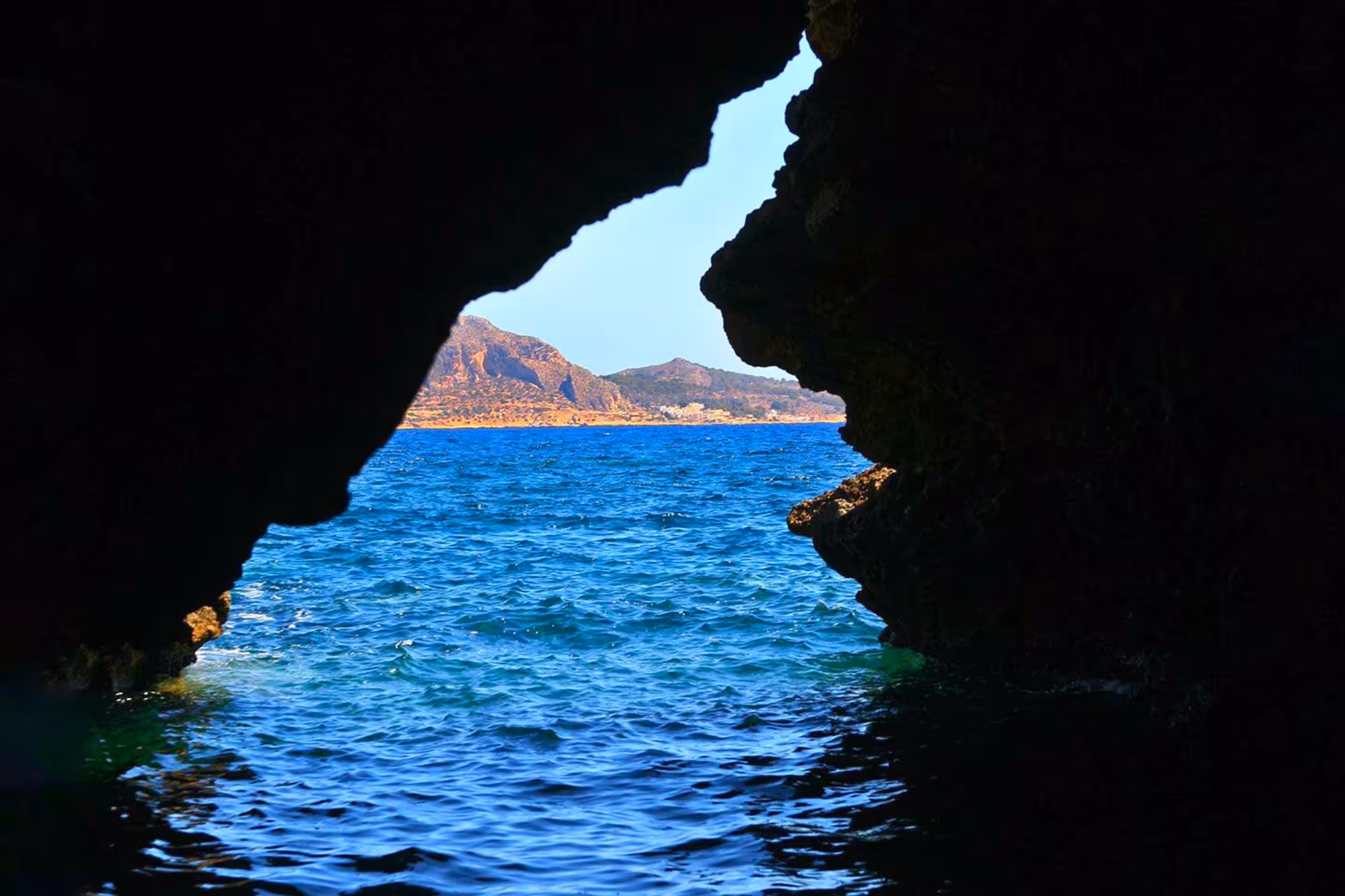 Sea cave opening on Favignana coastline, Egadi Islands private dinghy tour from Trapani with lunch included