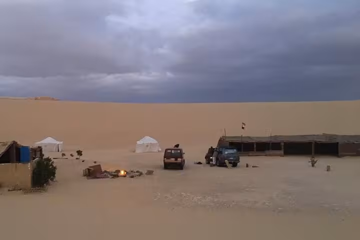 Experience a desert camp setup in the serene landscape of Fayoum Oasis on a private Jeep tour from Cairo or Giza.