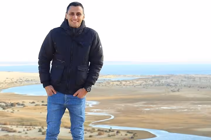 Tourist enjoying panoramic view of Fayoum Oasis landscape on a full day Jeep tour from Cairo or Giza.
