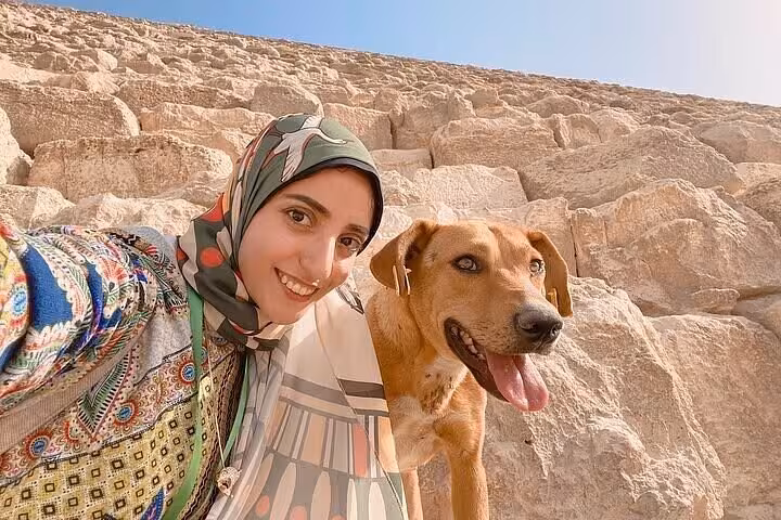 Traveler with friendly rescue dog in Fayoum desert, Whale Valley Wadi El Hitan and Magic Lake charity tour