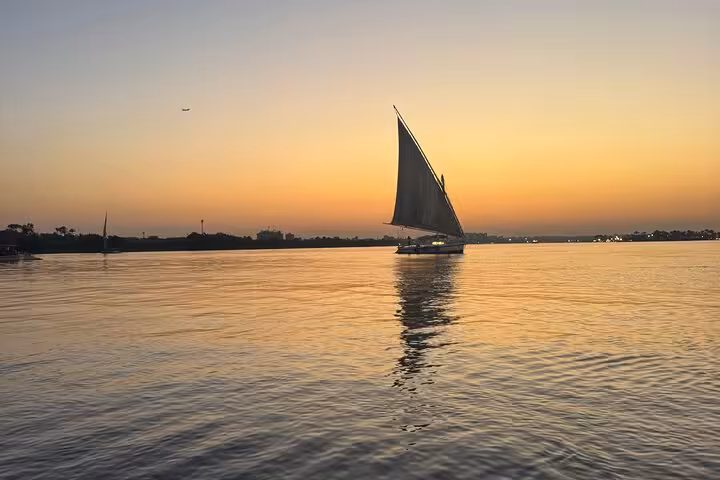 Felucca boat sailing on the Nile at sunset in Cairo, relaxing felucca ride with hotel pickup