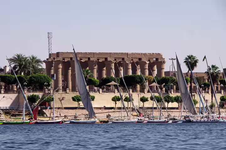 Felucca boats on the Nile with Luxor Temple columns, East Bank sightseeing tour to Karnak and Luxor