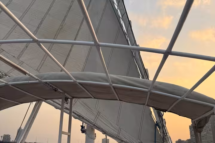 Close-up of felucca sail at sunset on the Nile River, relaxing Cairo pickup cruise experience