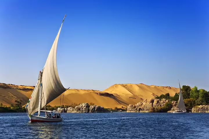 Felucca sailboat cruising the Nile near Luxor, scenic add-on for East and West Bank tour with temple visits