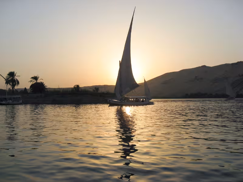 Felucca sailboat at sunset on the Nile River in Aswan, scenic moment on the Egypt & Jordan 5-star cruise itinerary