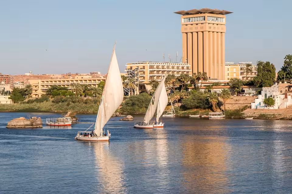 Felucca boats on the Nile in Cairo with city skyline views, sailing tour with lunch and round-trip transfer