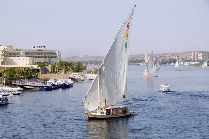 Traditional felucca sailing on the Nile River in Cairo, Egypt, scenic cruise with lunch and hotel transfer