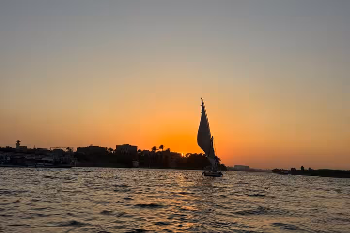 Traditional felucca cruise at sunset on the Nile in Cairo, peaceful sailing tour with Cairo pickup