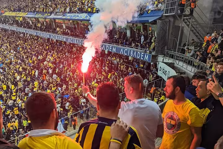 Fenerbahçe fans light flares in Istanbul stadium stands, electric matchday atmosphere on local football tour