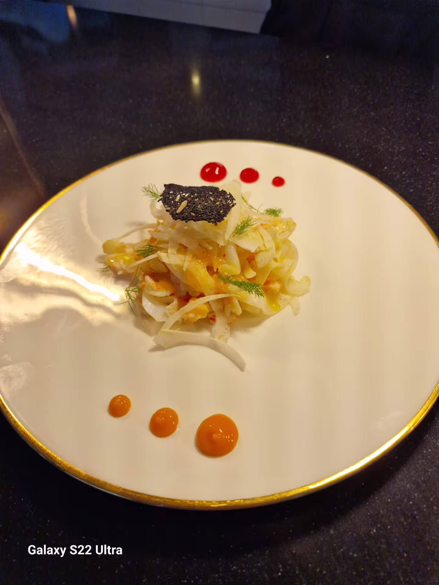 Elegant fennel salad with citrus dressing and sauce dots, served at chef Angelo Lanaro’s home dining